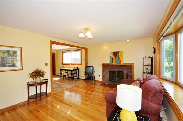 7 Senator Road Woburn, MA 01801 - Photo 3 of 26 a living room with furniture a fireplace and a large window