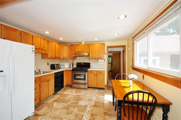 7 Senator Road Woburn, MA 01801 - Photo 5 of 26 a large kitchen with stainless steel appliances granite countertop a refrigerator a stove top oven a sink and dishwasher