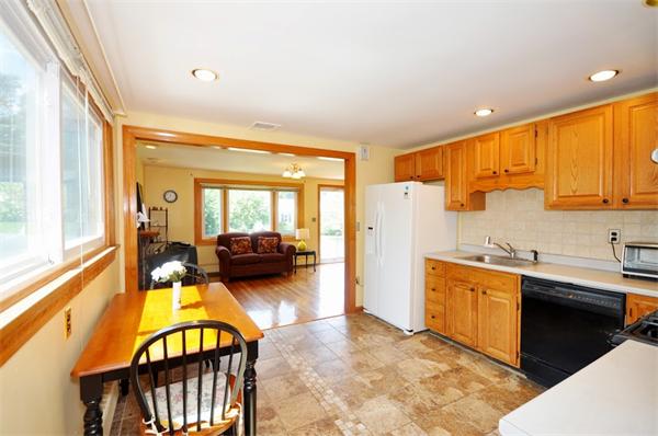 7 Senator Road Woburn, MA 01801 - Photo 6 of 26 a view of a kitchen with a sink and a refrigerator