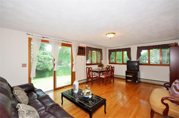 7 Senator Road Woburn, MA 01801 - Photo 7 of 26 a living room with furniture and a floor to ceiling window