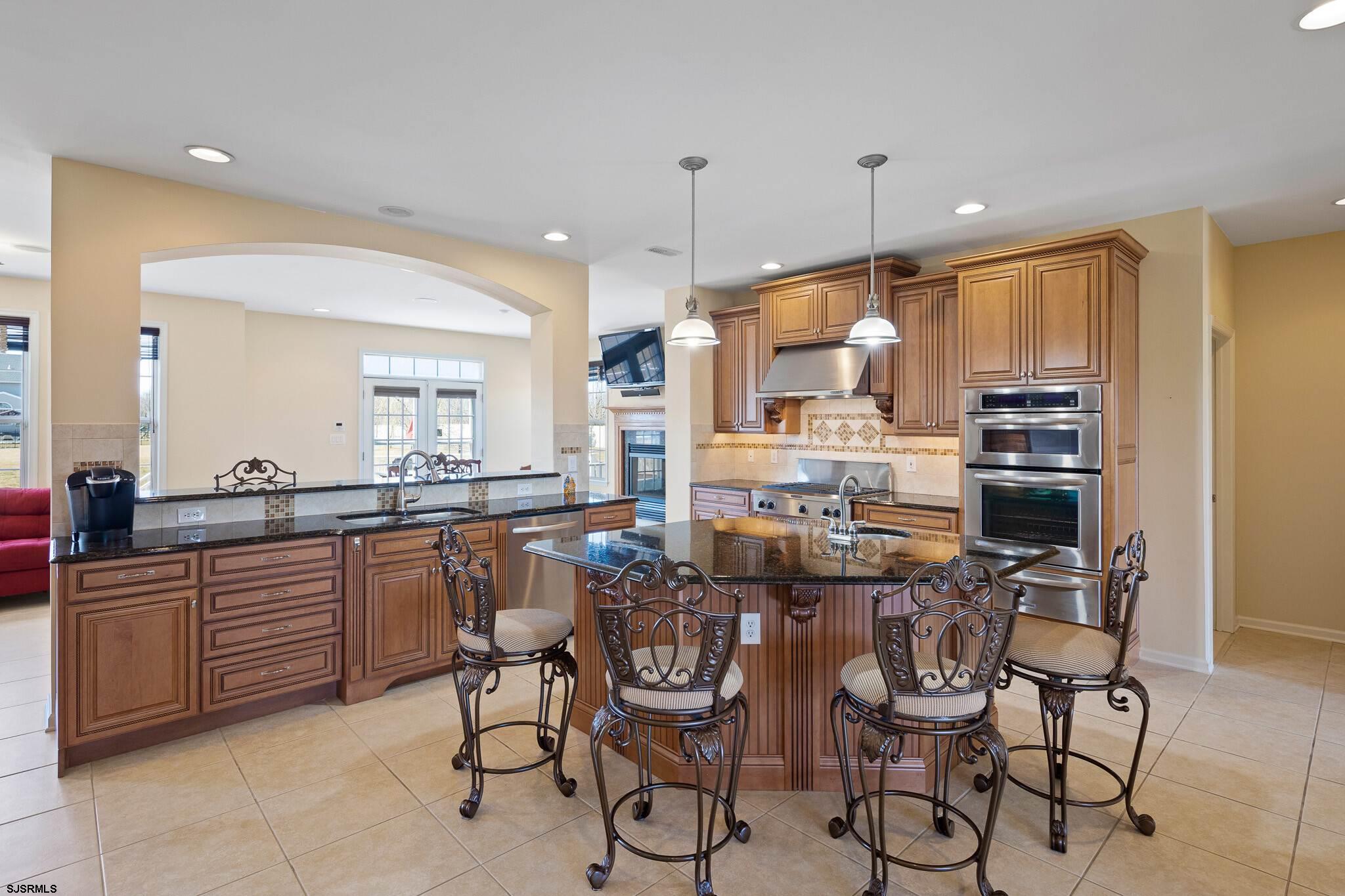 175 Greenview Court Clarksboro, NJ 08020 - Photo 12 of 25 a kitchen with stainless steel appliances kitchen island granite countertop a table chairs sink and cabinets