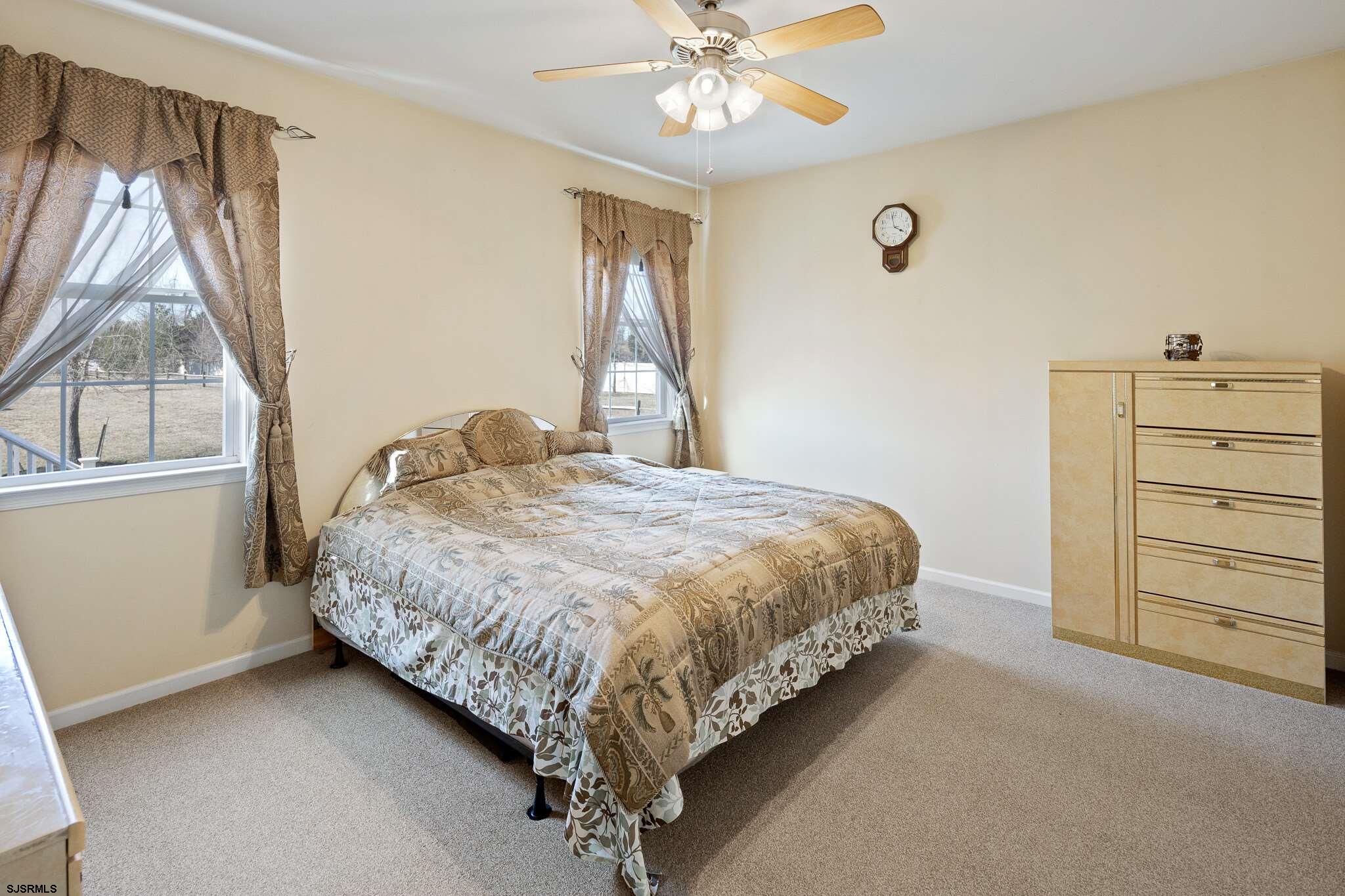 175 Greenview Court Clarksboro, NJ 08020 - Photo 20 of 25 a bedroom with a bed and a chandelier