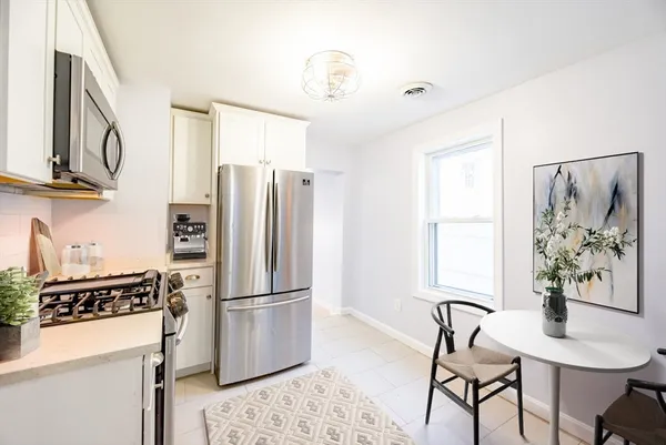 a kitchen with stainless steel appliances granite countertop a refrigerator and a stove