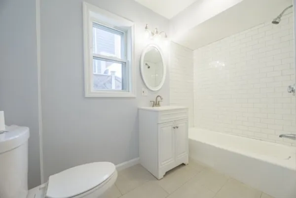 a bathroom with a toilet a sink and bathtub