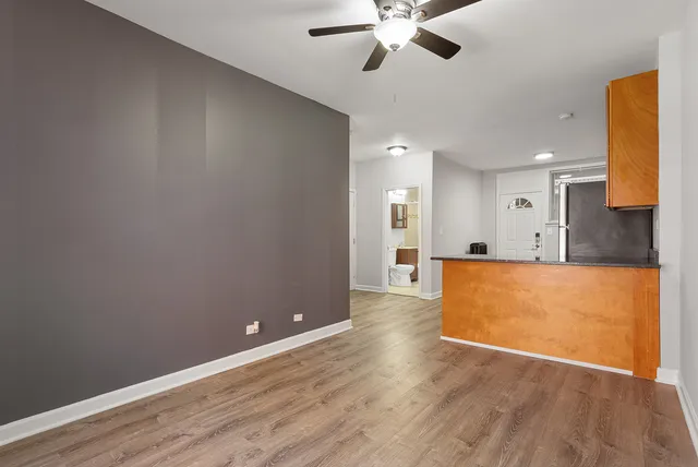 a view of kitchen with cabinets and wooden floor
