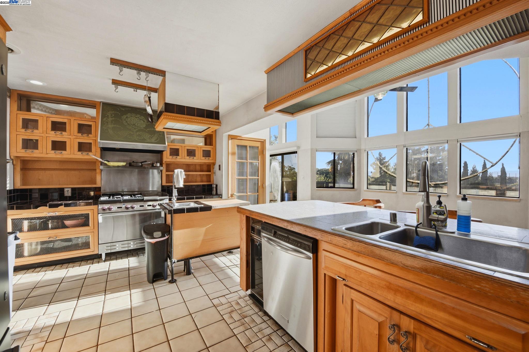 29673 Holiday Street Hayward, CA 94544 - Photo 12 of 47 a kitchen with stainless steel appliances granite countertop a stove and a sink