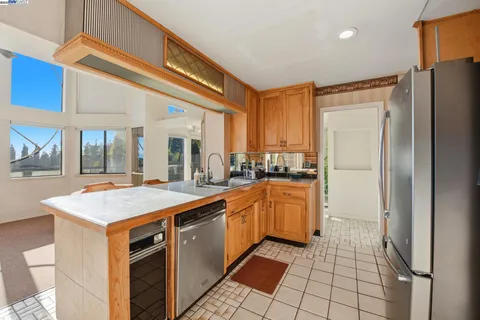 a kitchen with stainless steel appliances granite countertop a refrigerator and a sink