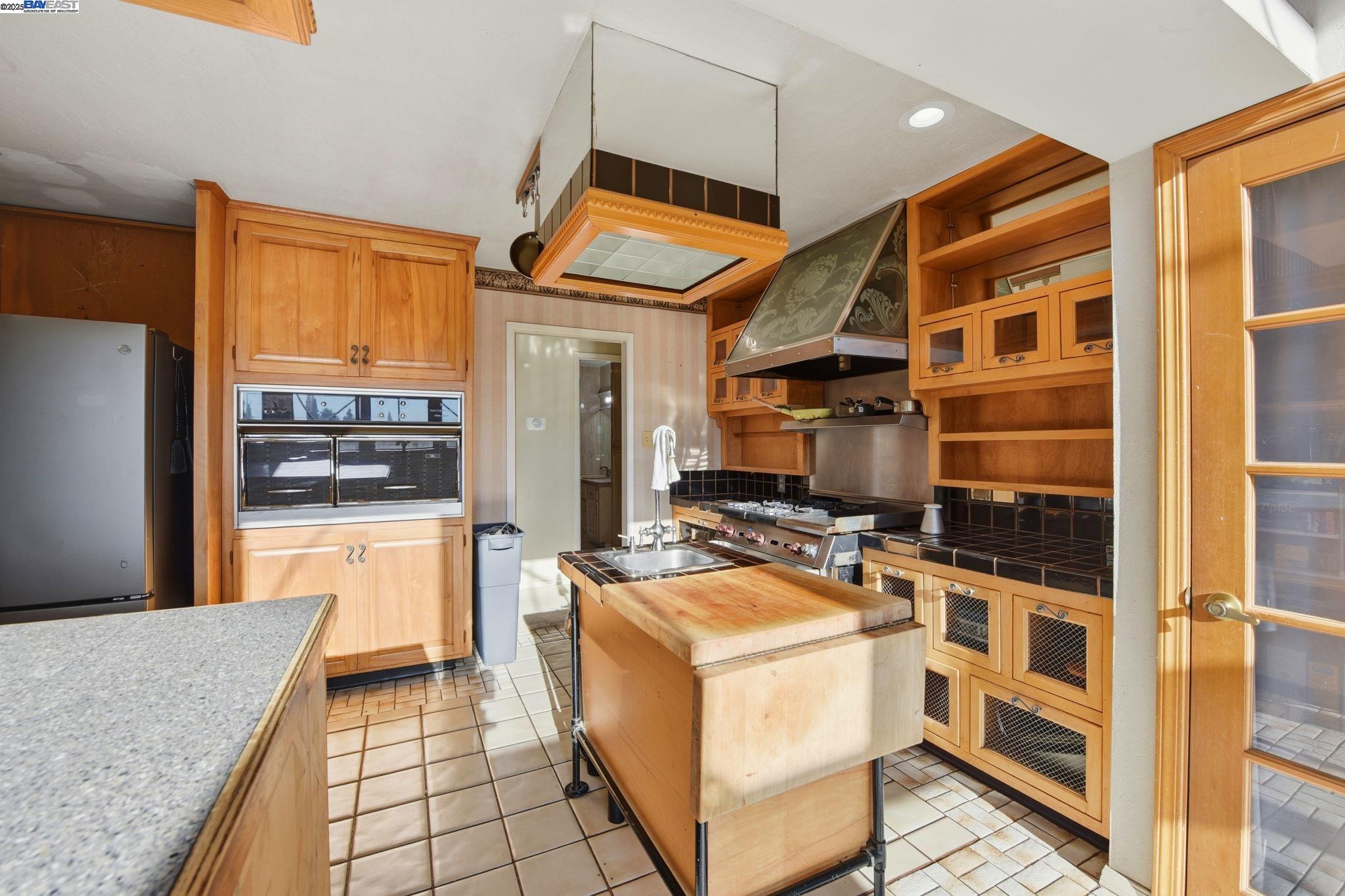 29673 Holiday Street Hayward, CA 94544 - Photo 15 of 47 a kitchen that has a stove and a wooden floor