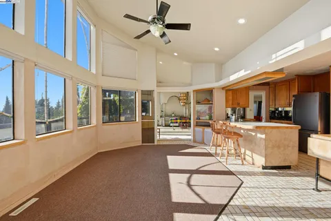 a view of a large kitchen with furniture and a window