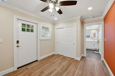 an empty room with fireplace and a ceiling fan