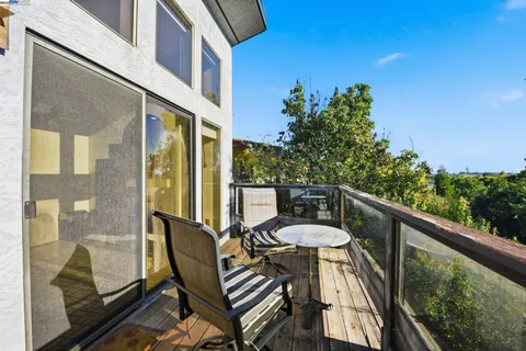 a balcony view with a seating space