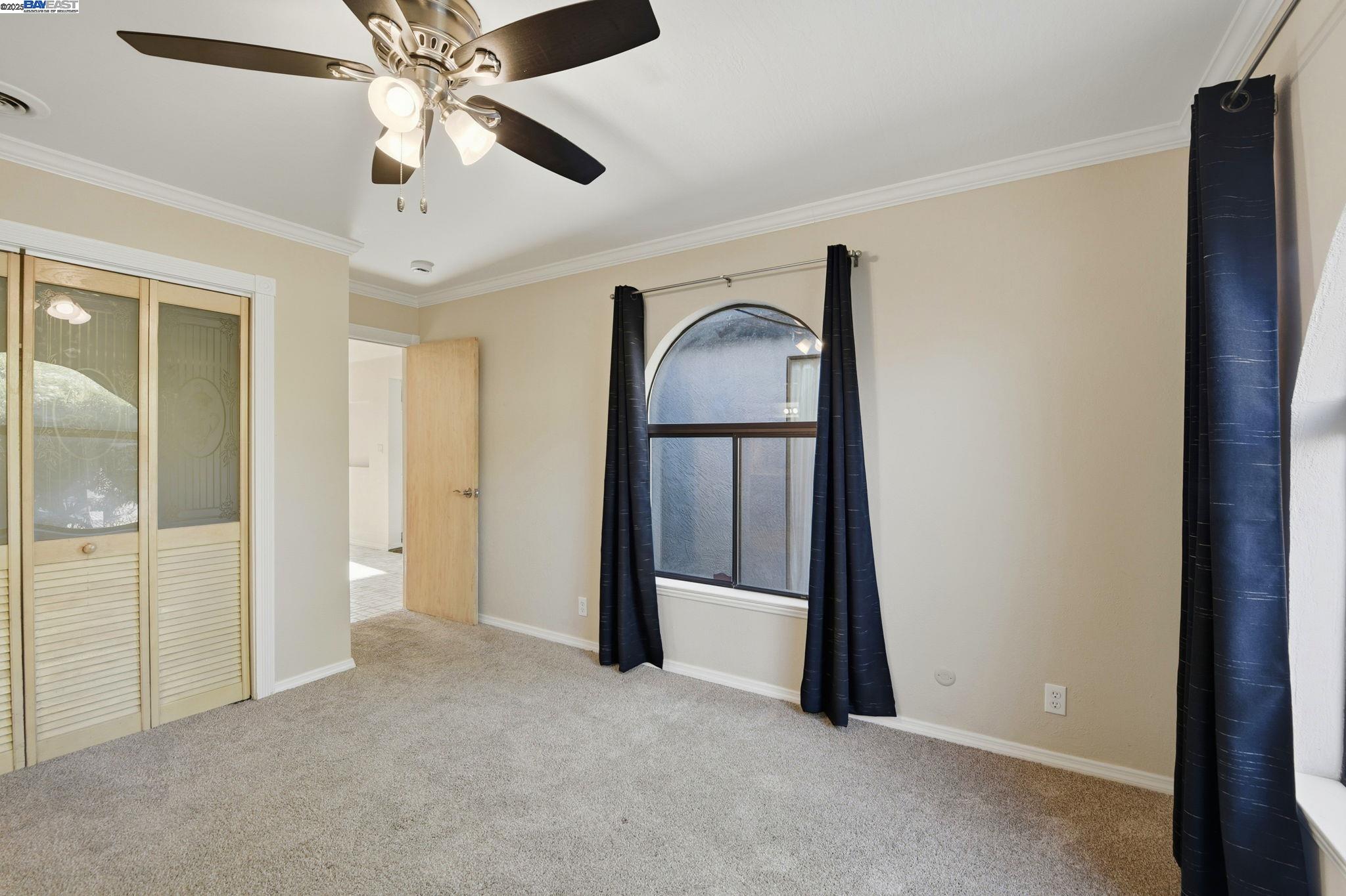 29673 Holiday Street Hayward, CA 94544 - Photo 31 of 47 an empty room with chandelier fan and windows