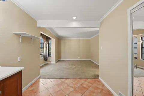 an empty room with a cabinet and mirrors