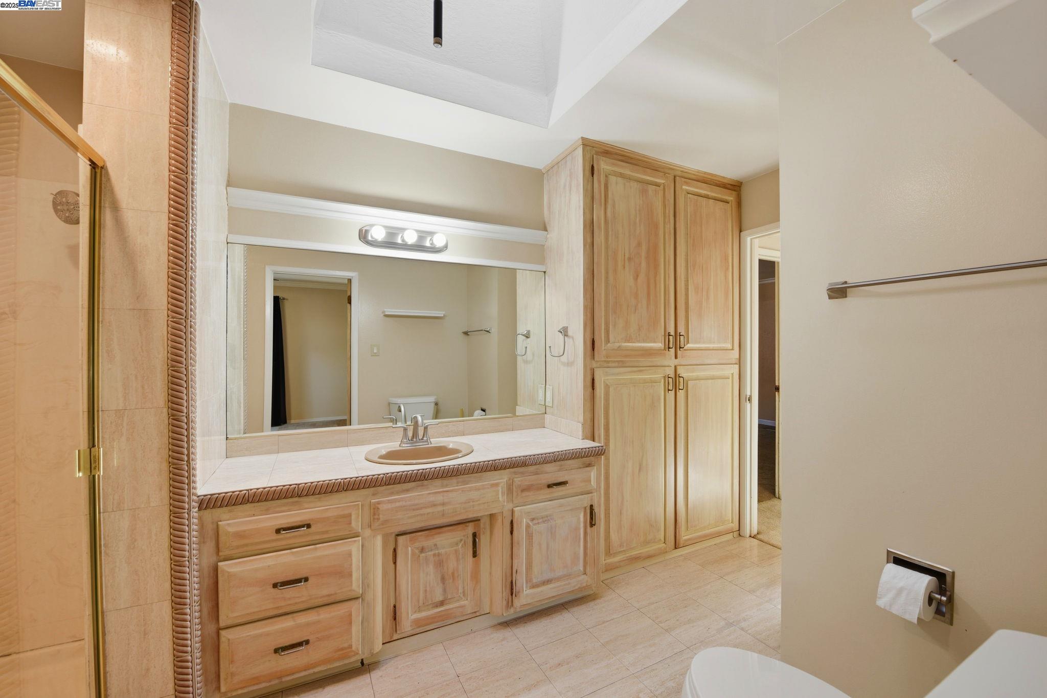 29673 Holiday Street Hayward, CA 94544 - Photo 38 of 47 a spacious bathroom with a shower a sink and a mirror