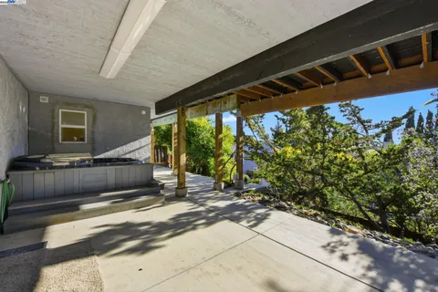 a bedroom with furniture and a wooden deck