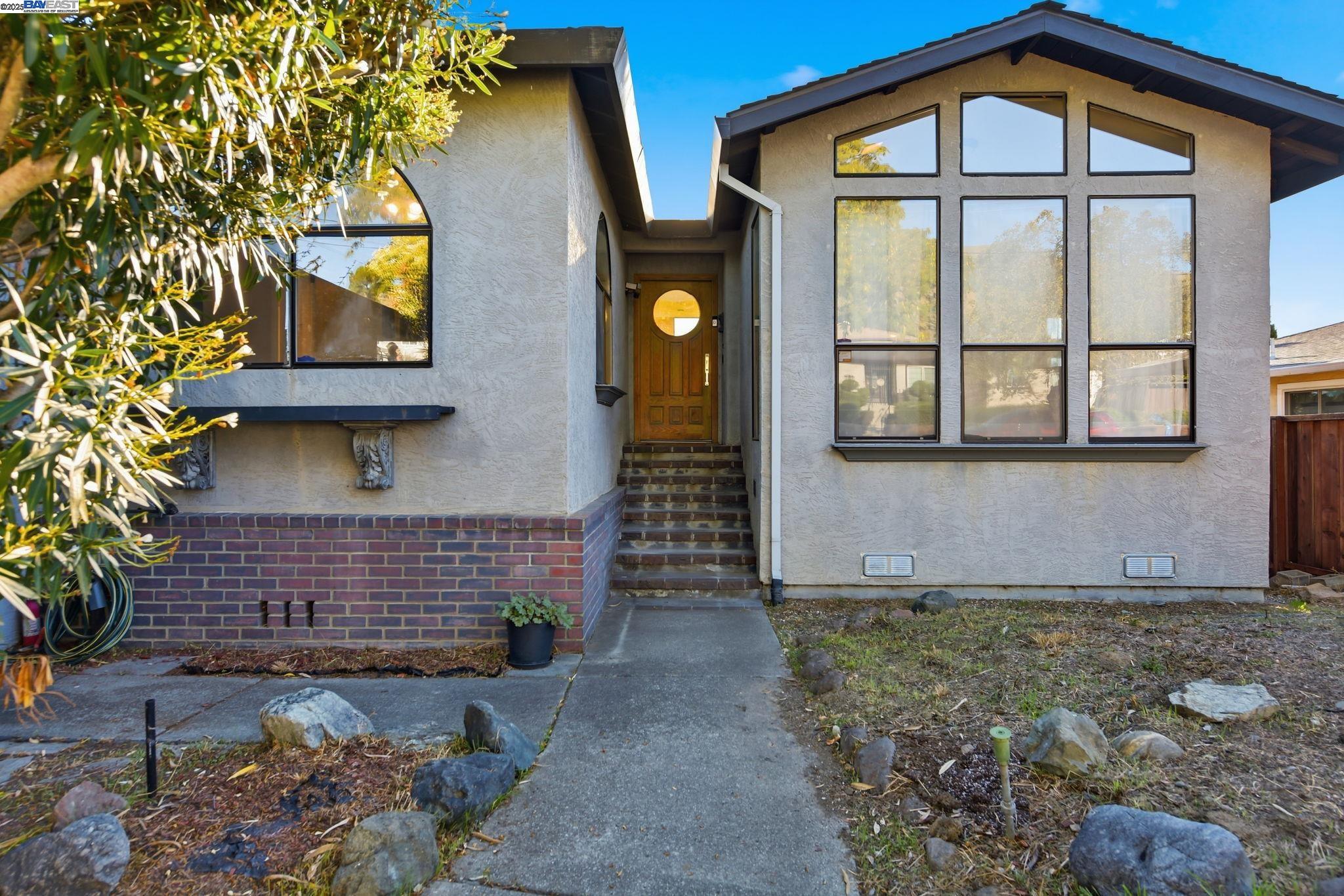 29673 Holiday Street Hayward, CA 94544 - Photo 7 of 47 a front view of a house with large windows