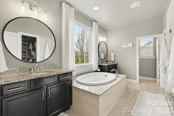 a bathroom with a granite countertop sink toilet and mirror