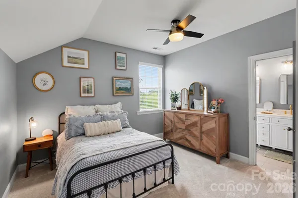 a living room with furniture and a ceiling fan