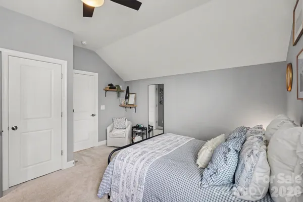 a bedroom with a large bed and a window