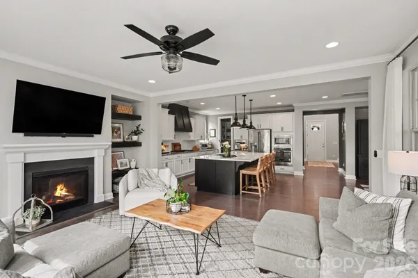 a kitchen with stainless steel appliances granite countertop a sink a stove and a refrigerator