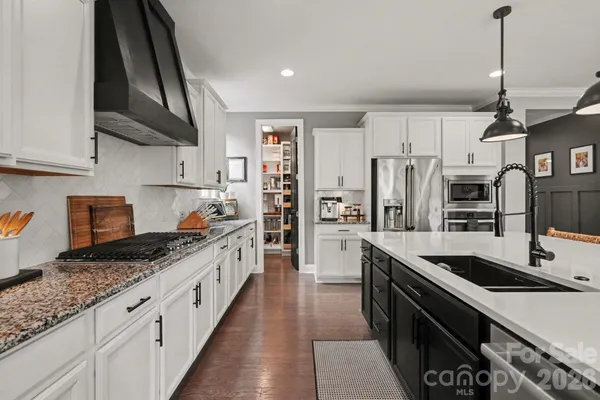 a large kitchen with a table and chairs
