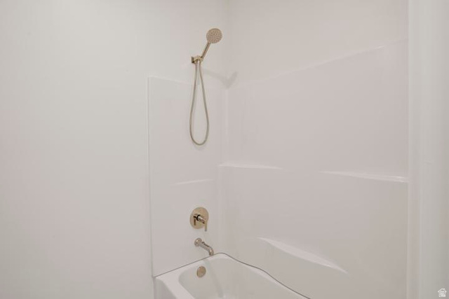 990 Manen Street Washington, UT 84780 - Photo 29 of 43 Bathtub and shower combination featuring white surround, brushed nickel fixtures, and a handheld showerhead