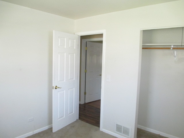 2106 Gideon Avenue Zion, IL 60099 - Photo 12 of 20 a view of a hallway with closet and wooden floor