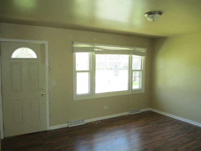 2106 Gideon Avenue Zion, IL 60099 - Photo 2 of 20 an empty room with wooden floor and windows
