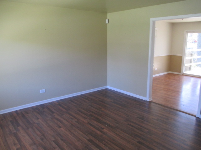 2106 Gideon Avenue Zion, IL 60099 - Photo 3 of 20 a view of empty room with wooden floor and fan