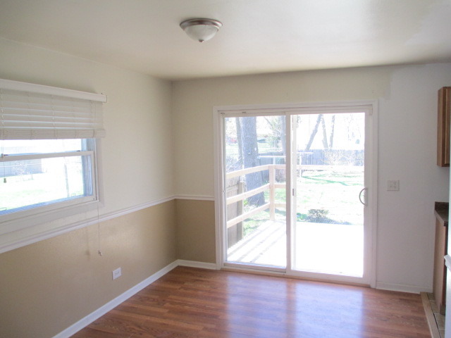 2106 Gideon Avenue Zion, IL 60099 - Photo 4 of 20 an empty room with wooden floor and windows