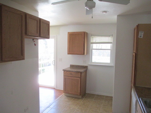 2106 Gideon Avenue Zion, IL 60099 - Photo 7 of 20 a kitchen with a refrigerator and a stove top oven
