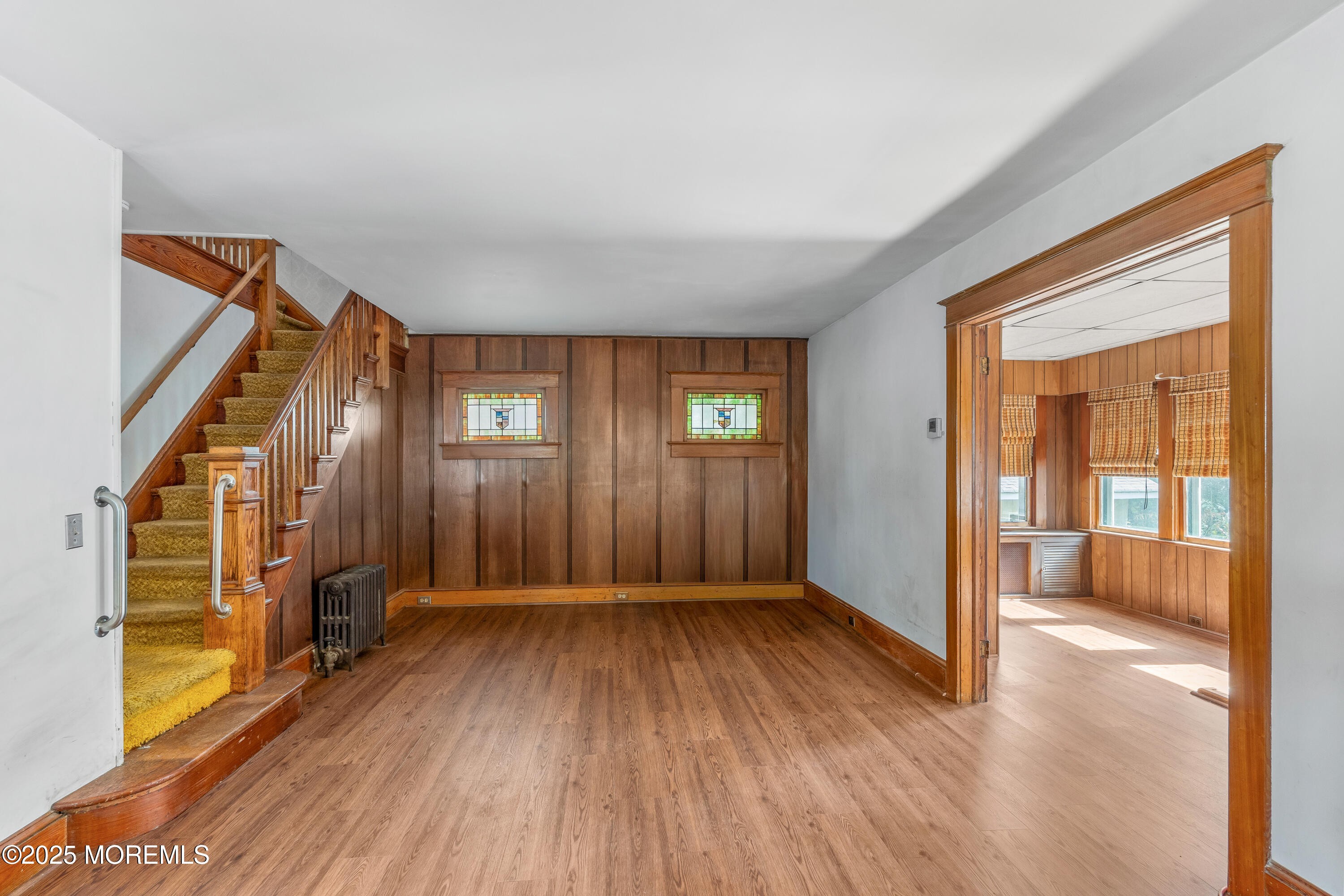 22 Mercer Avenue Port Monmouth, NJ 07758 - Photo 13 of 38 a view of an empty room with glass door and wooden floor