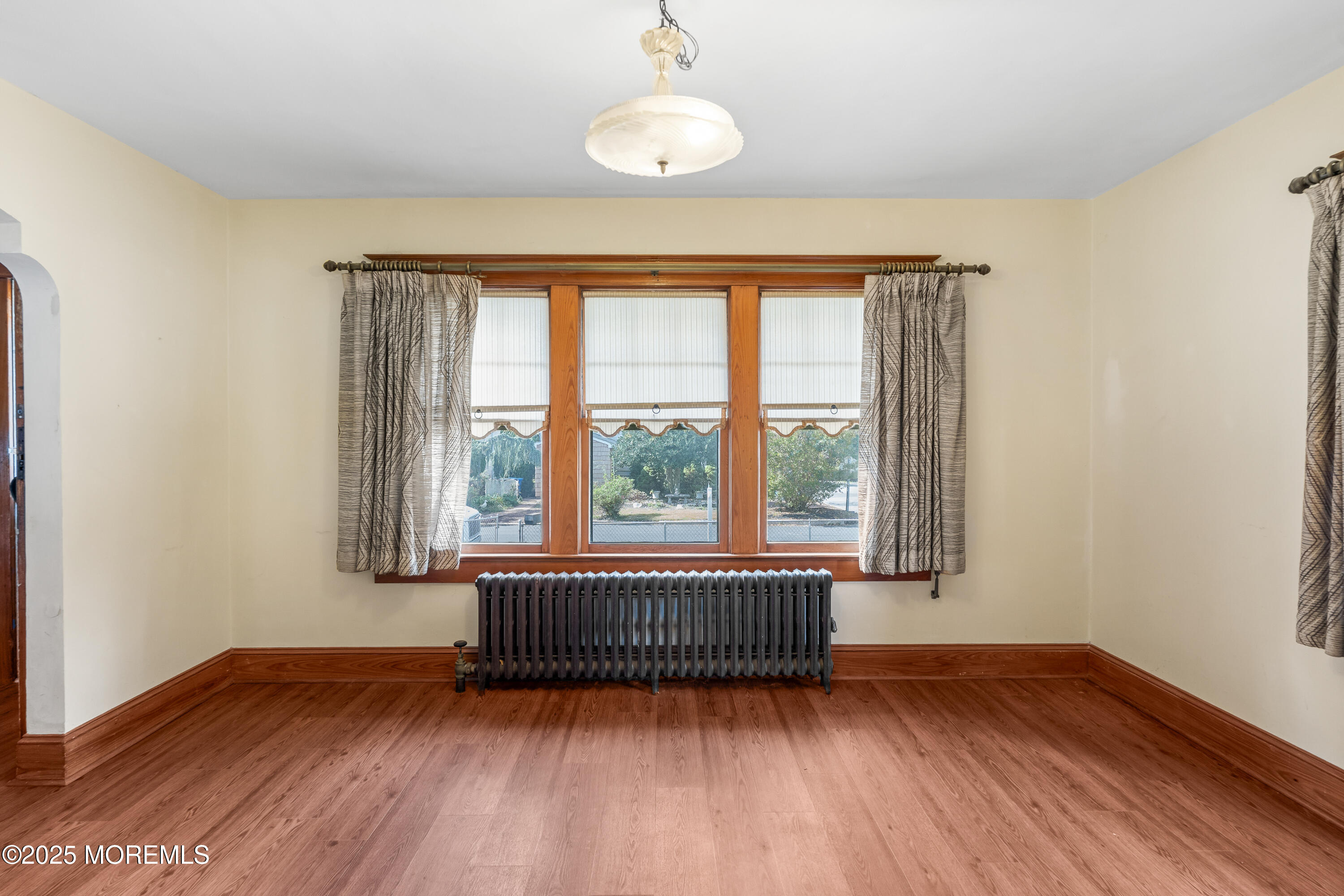 22 Mercer Avenue Port Monmouth, NJ 07758 - Photo 19 of 38 a view of an empty room with wooden floor and a window