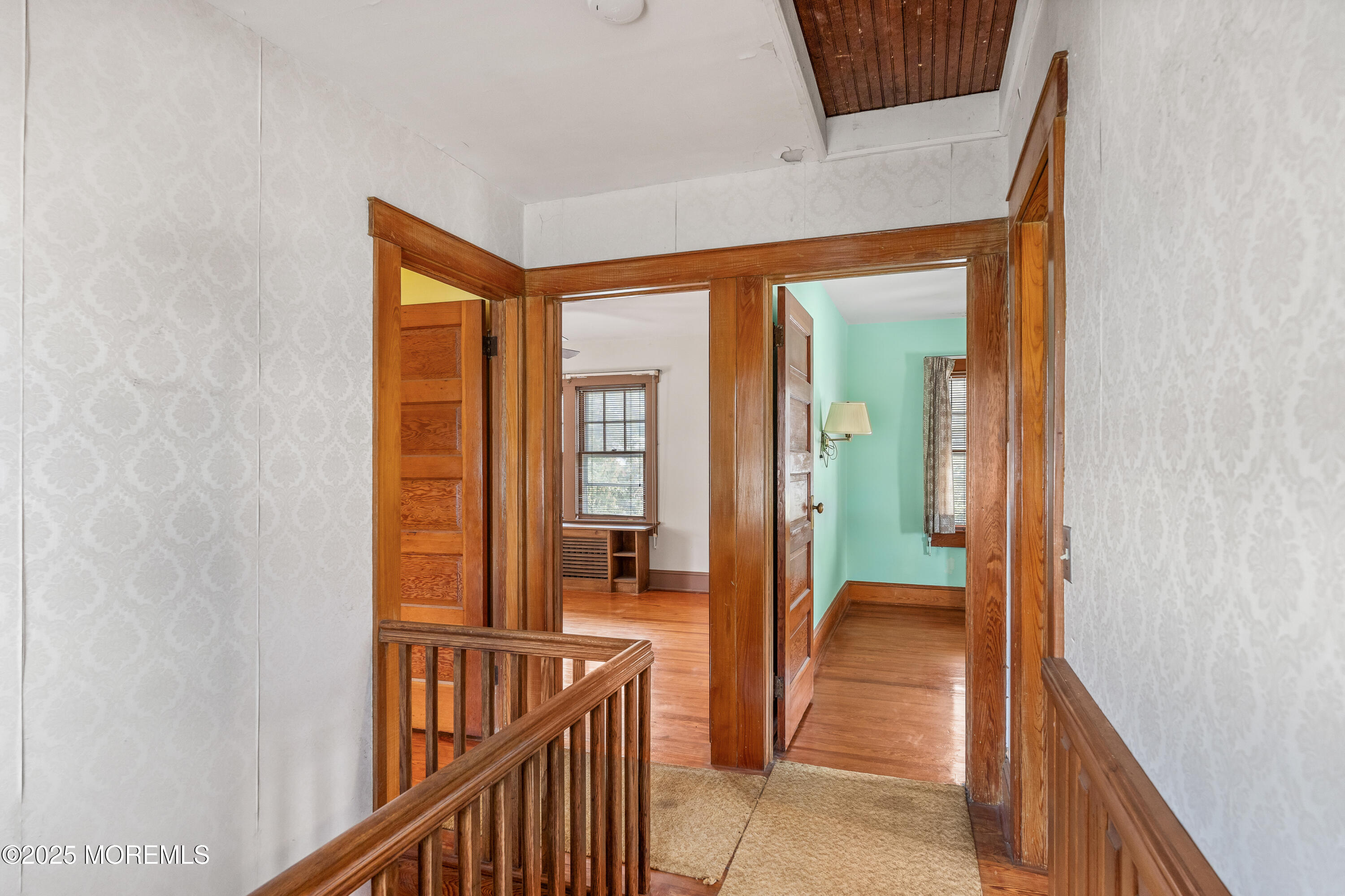 22 Mercer Avenue Port Monmouth, NJ 07758 - Photo 22 of 38 a view of a hallway with a livingroom and a bathroom with sink