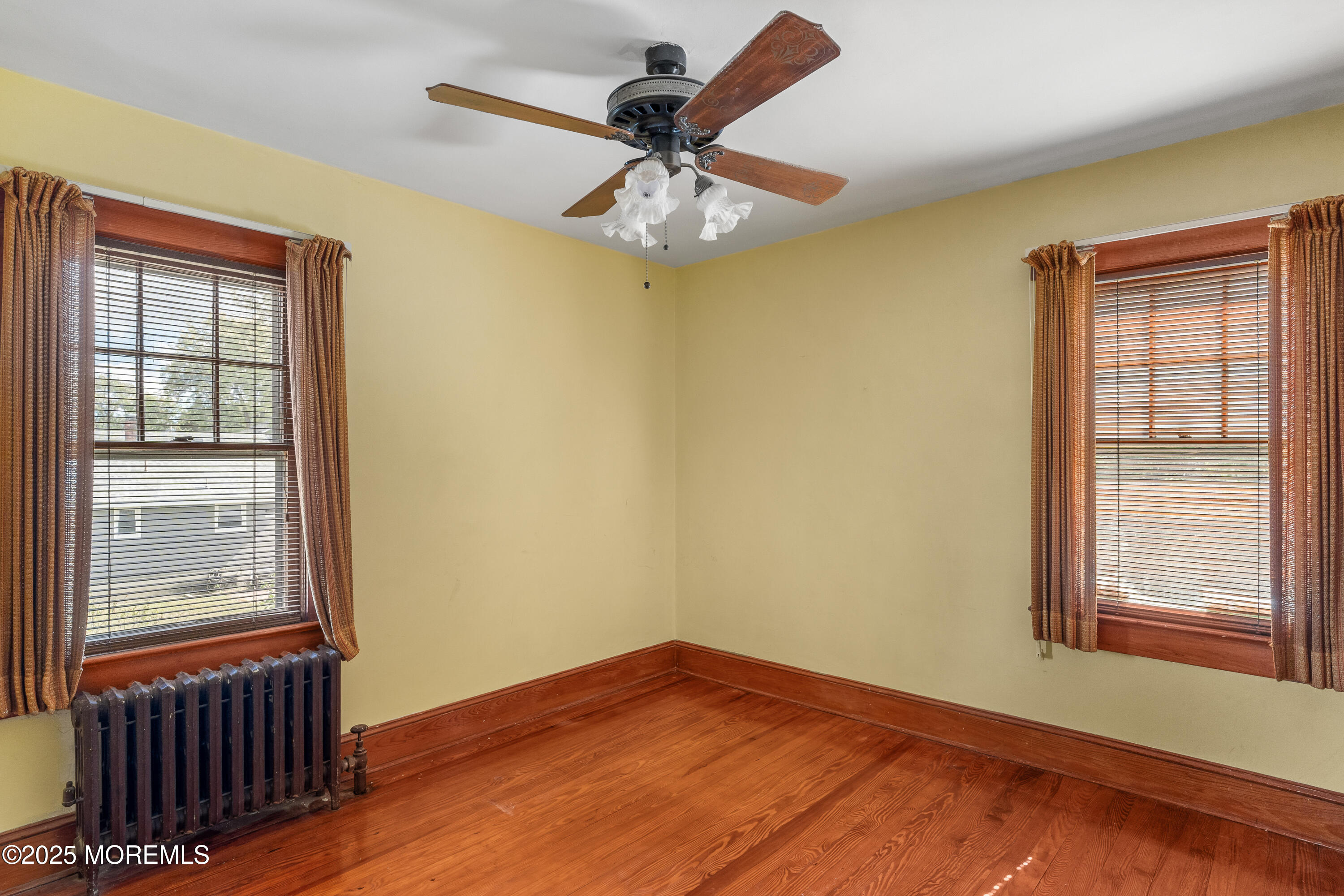 22 Mercer Avenue Port Monmouth, NJ 07758 - Photo 23 of 38 a view of empty room with wooden floor and fan