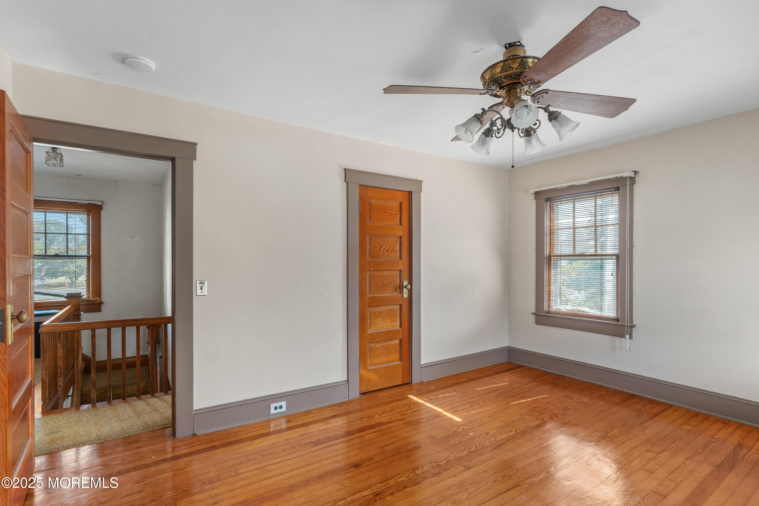 22 Mercer Avenue Port Monmouth, NJ 07758 - Photo 26 of 38 a view of an empty room with window and wooden floor