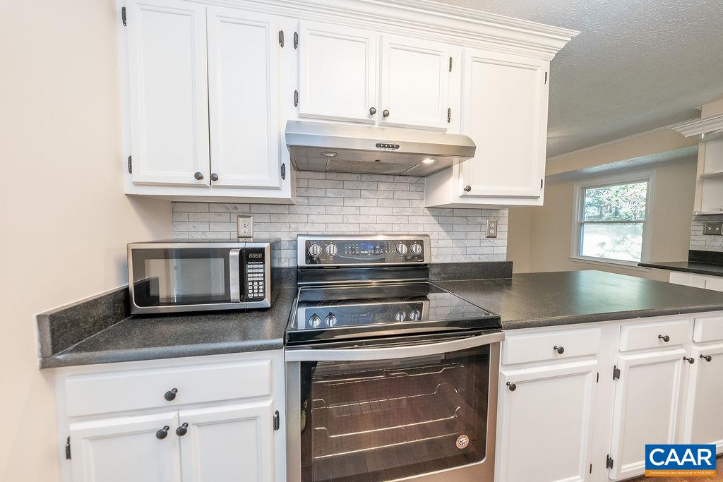 6156 Advance Mills Road Ruckersville, VA 22968 - Photo 11 of 54 a kitchen with granite countertop white cabinets and appliances