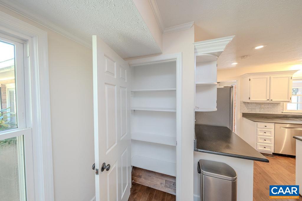6156 Advance Mills Road Ruckersville, VA 22968 - Photo 12 of 54 a kitchen with a refrigerator and white cabinets