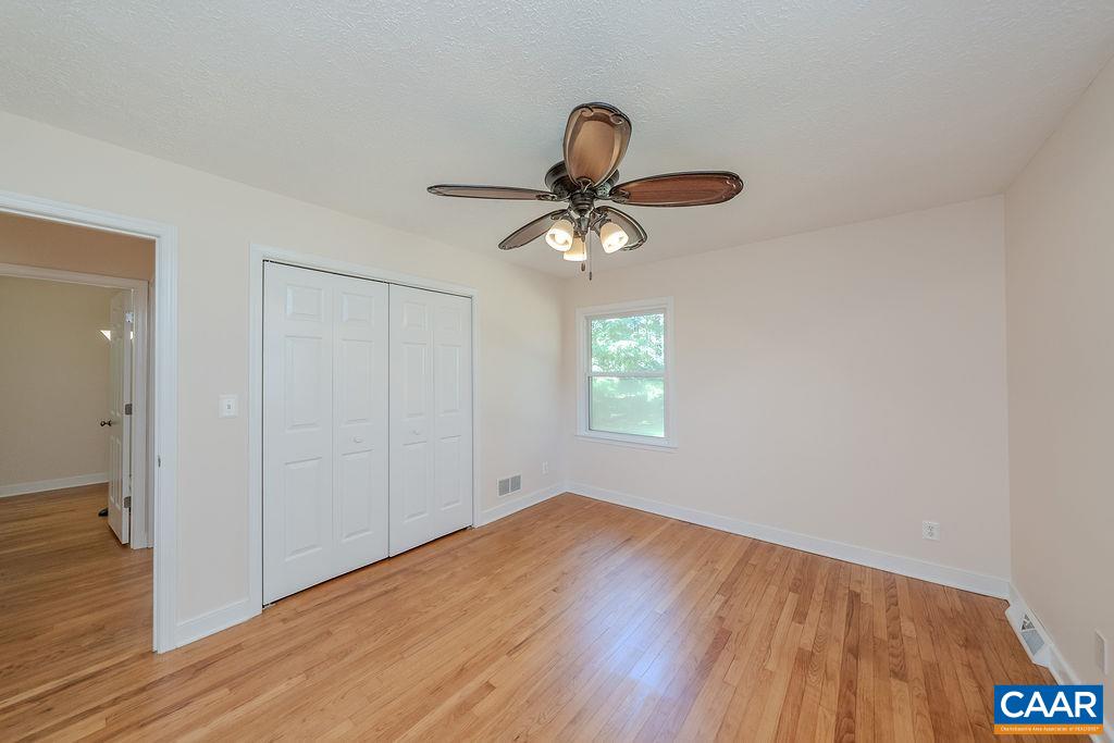 6156 Advance Mills Road Ruckersville, VA 22968 - Photo 17 of 54 a view of an empty room with wooden floor and a window