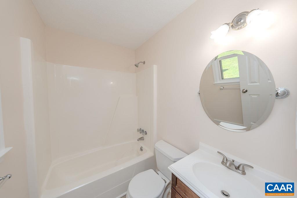 6156 Advance Mills Road Ruckersville, VA 22968 - Photo 18 of 54 a bathroom with a sink mirror bathtub and toilet