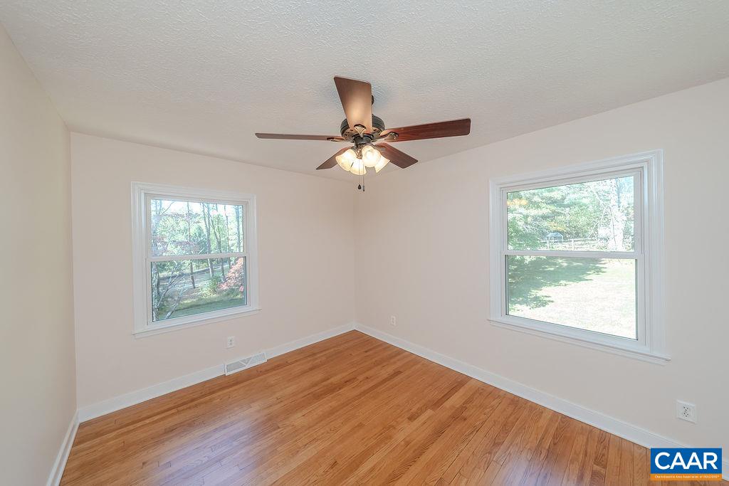 6156 Advance Mills Road Ruckersville, VA 22968 - Photo 19 of 54 a view of an empty room with wooden floor and a window