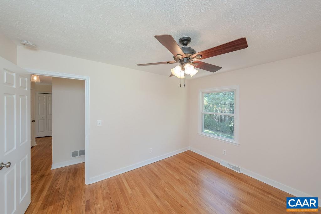 6156 Advance Mills Road Ruckersville, VA 22968 - Photo 21 of 54 an empty room with wooden floor and a window