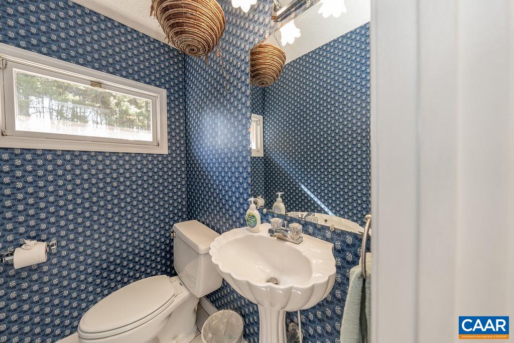 6156 Advance Mills Road Ruckersville, VA 22968 - Photo 25 of 54 a bathroom with a sink a toilet and mirror