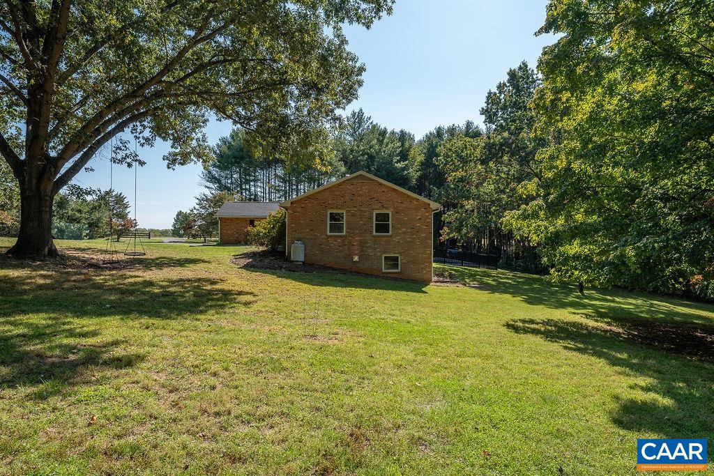 6156 Advance Mills Road Ruckersville, VA 22968 - Photo 37 of 54 a house with a big yard with large trees