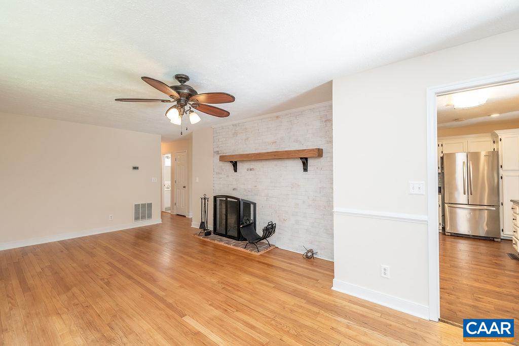 6156 Advance Mills Road Ruckersville, VA 22968 - Photo 4 of 54 a view of a livingroom with a hardwood floor and a ceiling fan