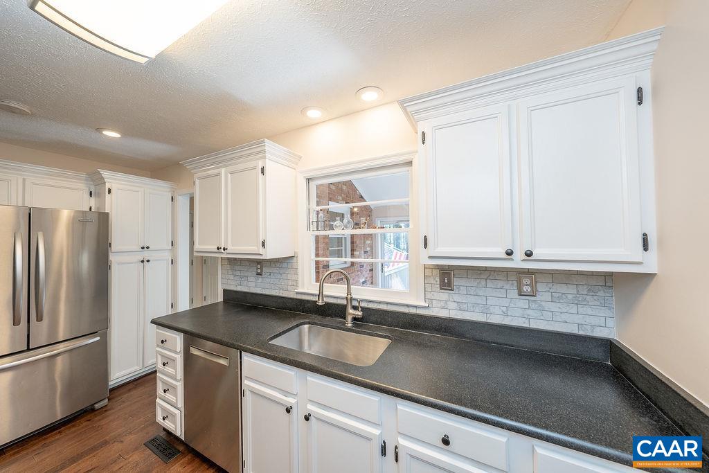 6156 Advance Mills Road Ruckersville, VA 22968 - Photo 9 of 54 a kitchen with stainless steel appliances granite countertop a sink a refrigerator and white cabinets