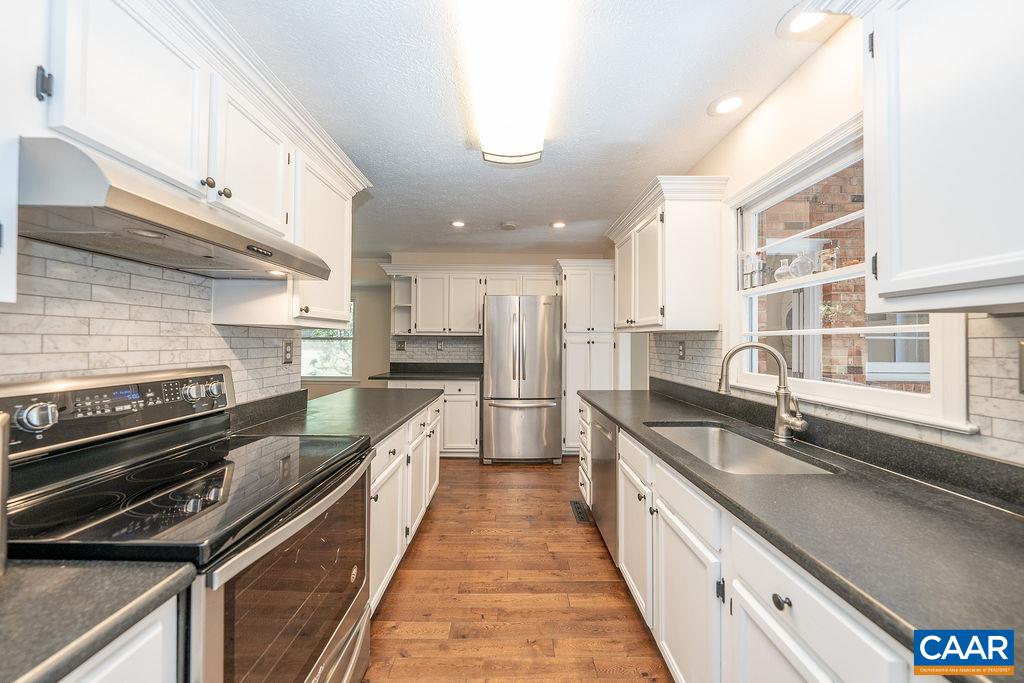 6156 Advance Mills Road Ruckersville, VA 22968 - Photo 10 of 54 a large kitchen with a large counter top appliances and cabinets