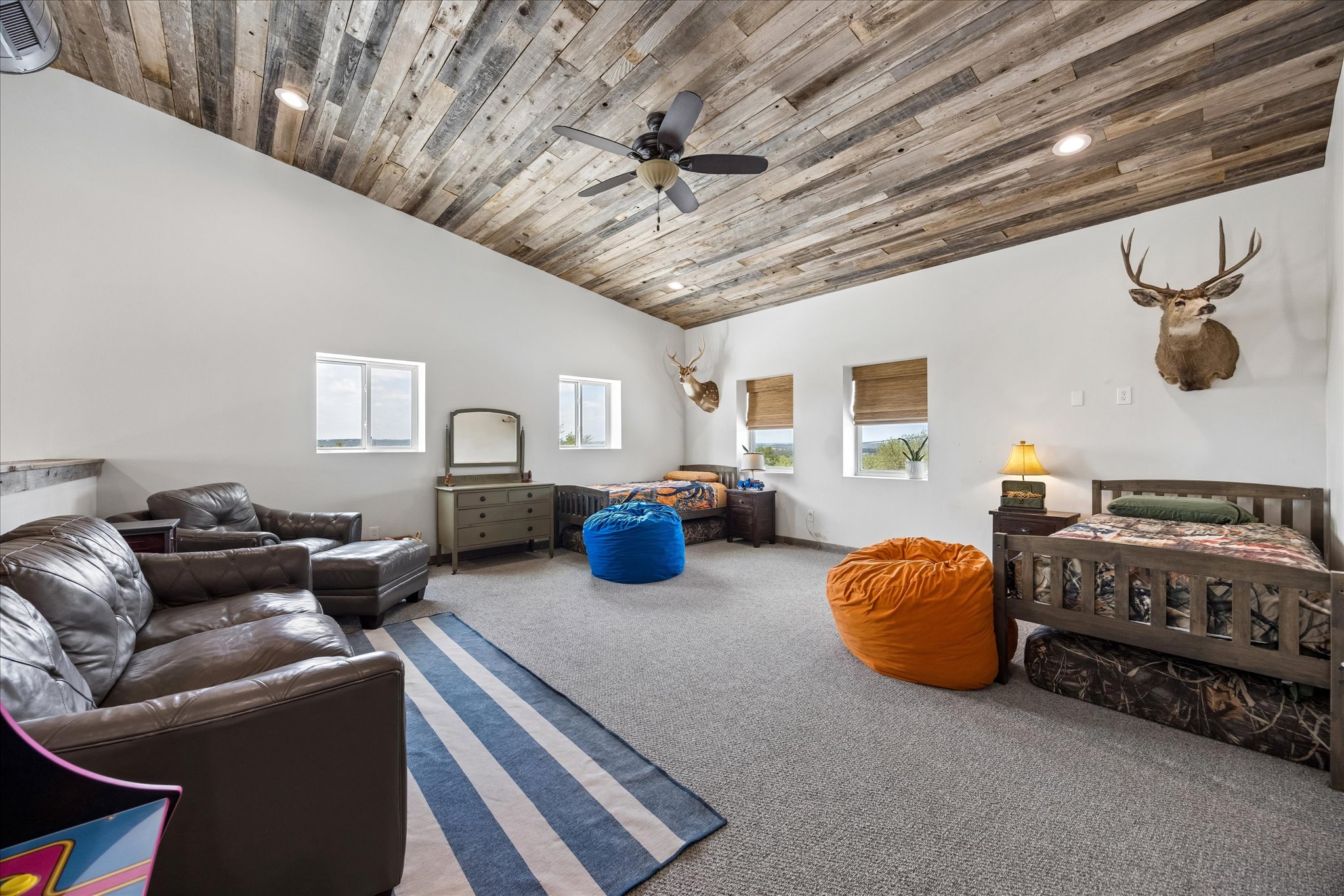 6411 West Fitzhugh Road Dripping Springs, TX 78620 - Photo 17 of 34 Vaulted ceiling featuring wood-finish paneling and recessed lighting