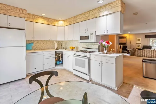 a kitchen with a sink appliances cabinets and furniture
