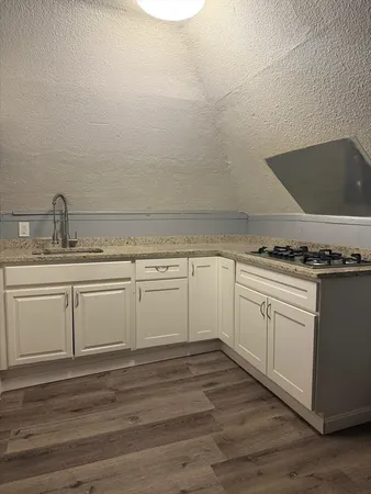a view of a kitchen with cabinets and appliances